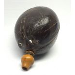 Napoleonic coconut bug bear flask with carved decoration and initials, inset glass eyes and turned b