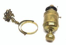 Ship's bulkhead mounting brass oil lamp of drum shaped form, gimbal mounted on dolphin shaped bracke