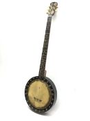Early 20th century five-string banjo with ebonised frame and walnut neck, the headstock with engrave
