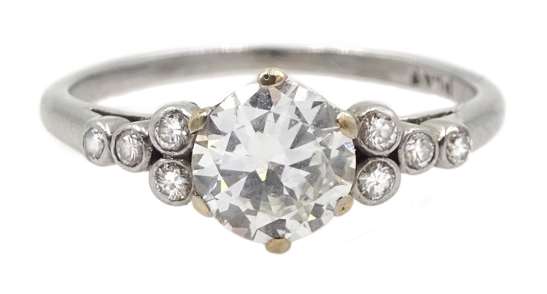 Platinum single stone diamond ring, with four diamonds set either side, stamped PLAT, central diamon