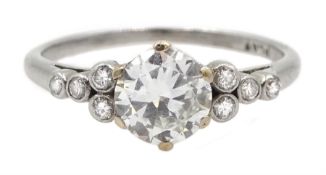 Platinum single stone diamond ring, with four diamonds set either side, stamped PLAT, central diamon