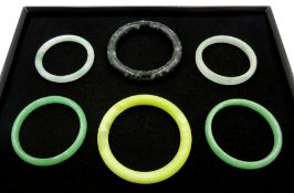 Four green jade bangles and two other bangles
