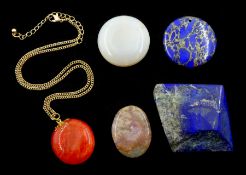 Lapis lazuli, jade and stone pendants and a piece of polished lapis lazuli stone
