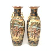 A pair of Chinese floor vases, of baluster form with frilled rim and twin gilt handles, decorated wi