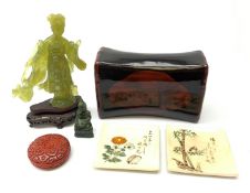 A Chinese translucent green hardstone figure, modelled as Guanyin, raised upon a wooden base, figure