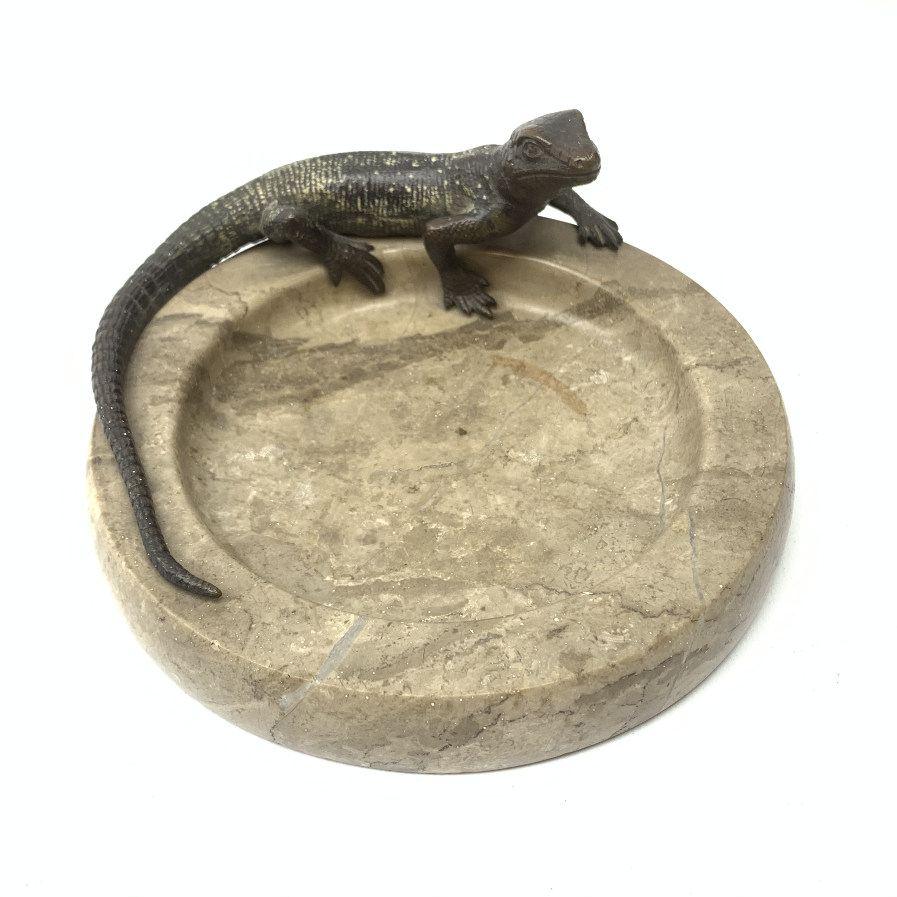 A cold painted bronze Australian lizard, mounted upon a polished stone dish, D15.5cm.