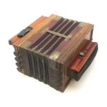 Early 20th century German ten-button accordion with simulated wood grain finish, the metal mounts w