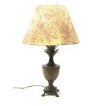 A cast metal table lamp, the base of square form with four pad feet leading to a spreading food, obl