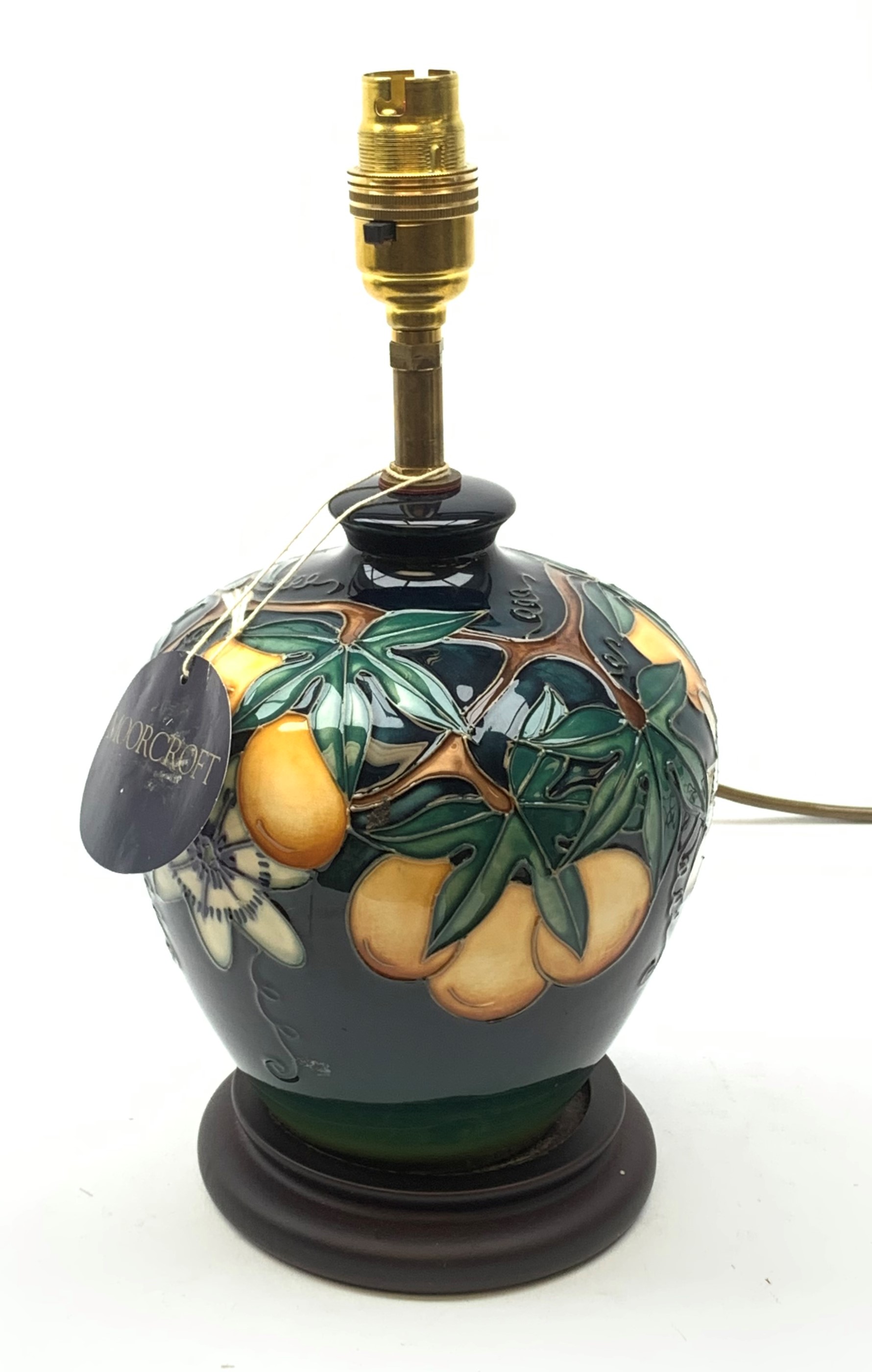 A Moorcroft table lamp, in the Passion Fruit pattern, designed by Rachel Bishop, raised upon a stepp