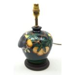 A Moorcroft table lamp, in the Passion Fruit pattern, designed by Rachel Bishop, raised upon a stepp