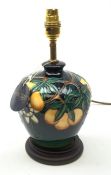 A Moorcroft table lamp, in the Passion Fruit pattern, designed by Rachel Bishop, raised upon a stepp