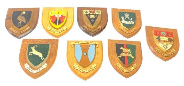 A group of eight wooden Military and School plaques, comprising King's African Rifles, Kenya Regimen