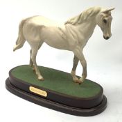 A Royal Doulton figurine modelled as the race horse Desert Orchid, upon a wooden oval base.