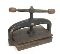 A late 19th century cast iron book press, L48cm, H36cm.