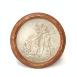 A large neoclassical style plaster wall plaque, of circular form within a faux marble effect frame,