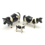 A Beswick Friesion Bull, marked Coddington Hilt Bar, a Friesion Cow, marked Ch Claybury Leegwater, a