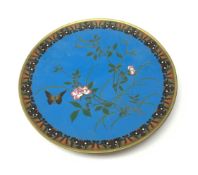 A Japanese cloisonne dish, of circular form, the blue ground decorated with blossoming vines and a b