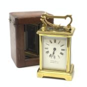 A brass cased carriage clock, the white enamel dial with black Roman numerals, marked Pearch & Sons