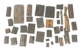 A collection of various Vintage woodblock letter stamps.