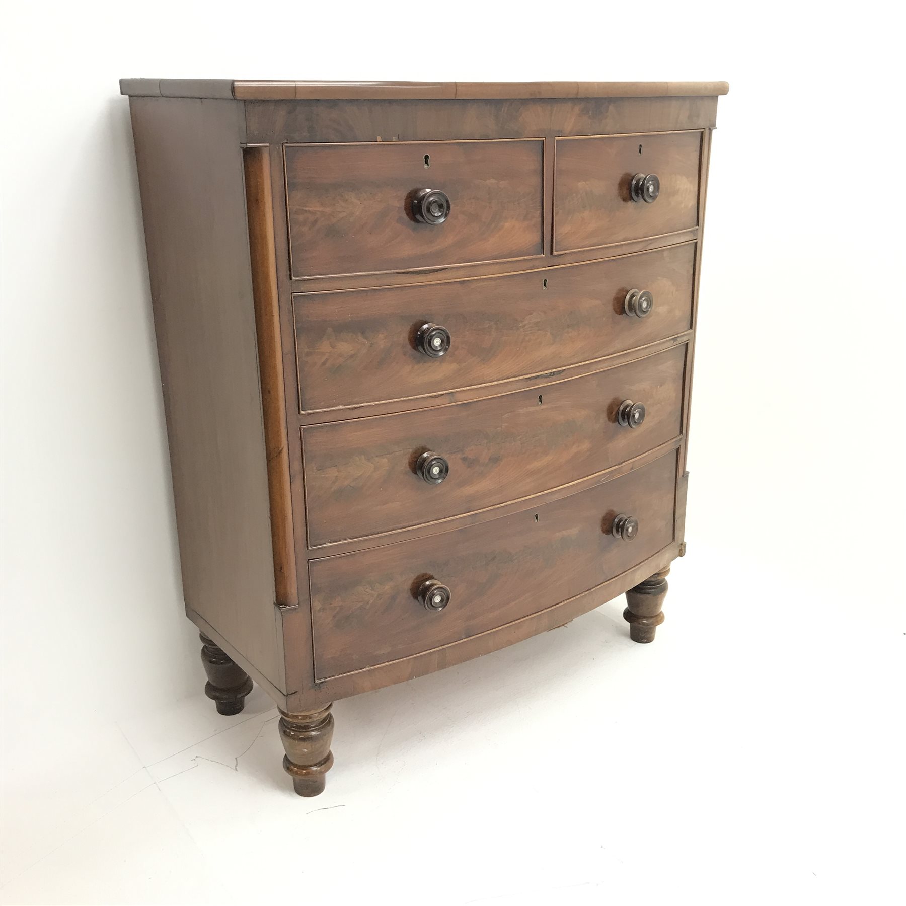 Victorian mahogany bow front chest, two short and three long drawers, turned supports, W113cm, H132c