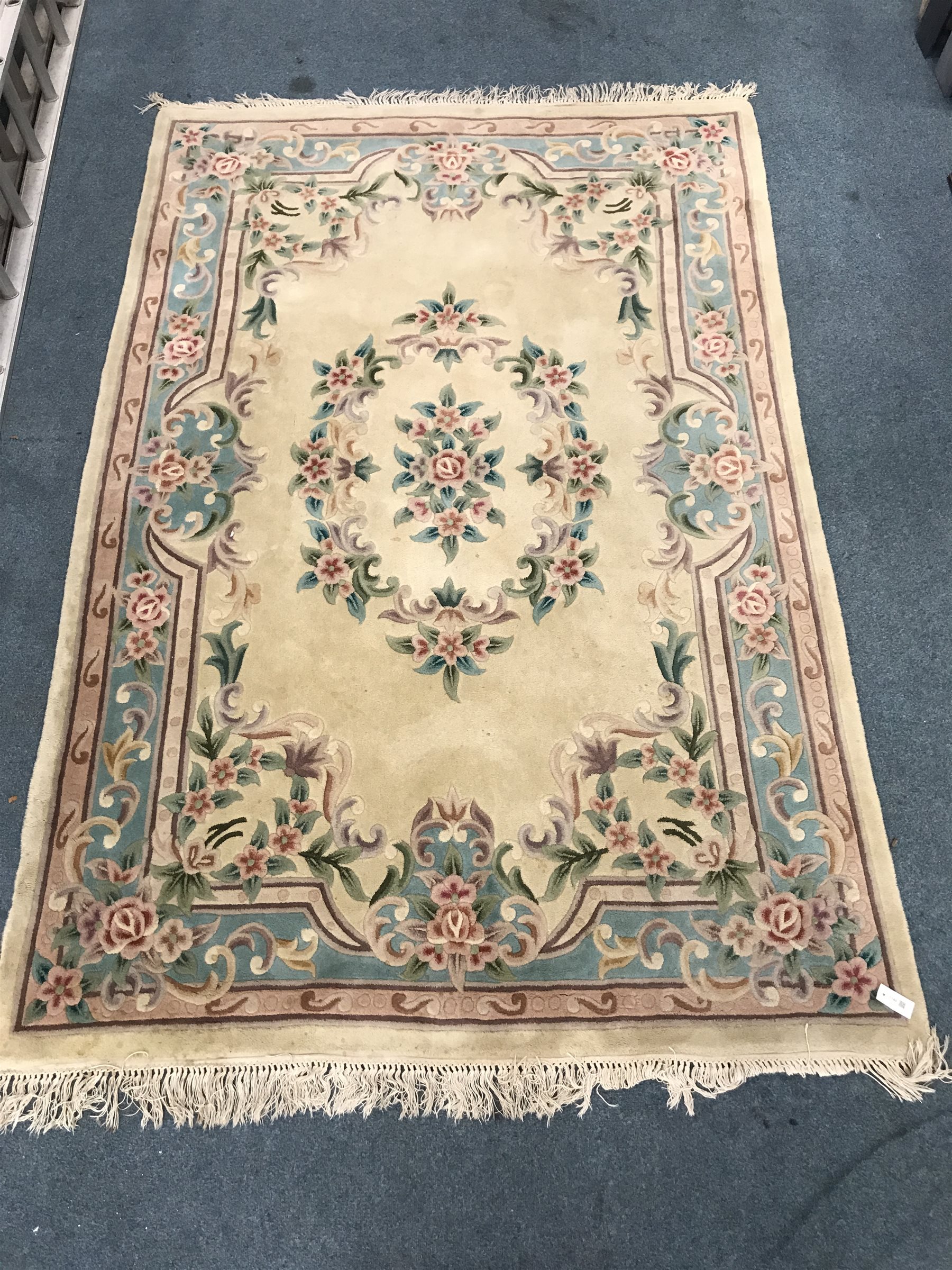 Chinese style beige ground rug, central medallion, repeating border, 276cm x 183cm