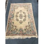 Chinese style beige ground rug, central medallion, repeating border, 276cm x 183cm