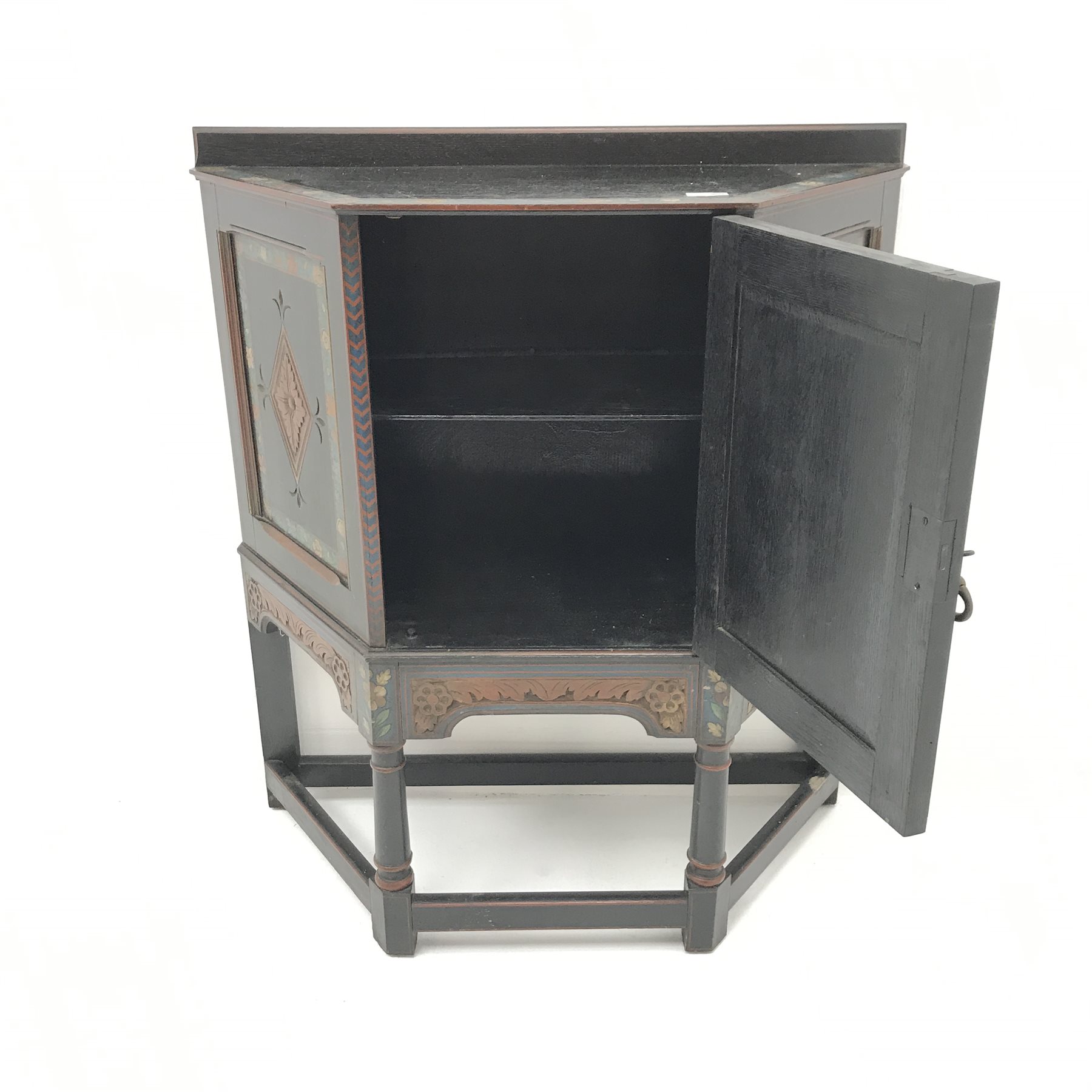 Early 20th century credence cupboard, painted black finish, carved panels, turned supports joined by