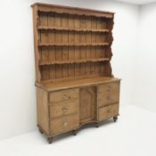 Victorian and later pine dresser, raised three tier plate rack, six graduating drawers flanking sing