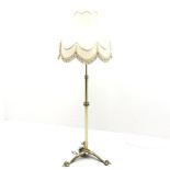 Brass standard lamp, three splayed supports, H143cm