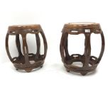 Pair Chinese rosewood circular barrel shaped occasional tables, five shaped supports joined by stret