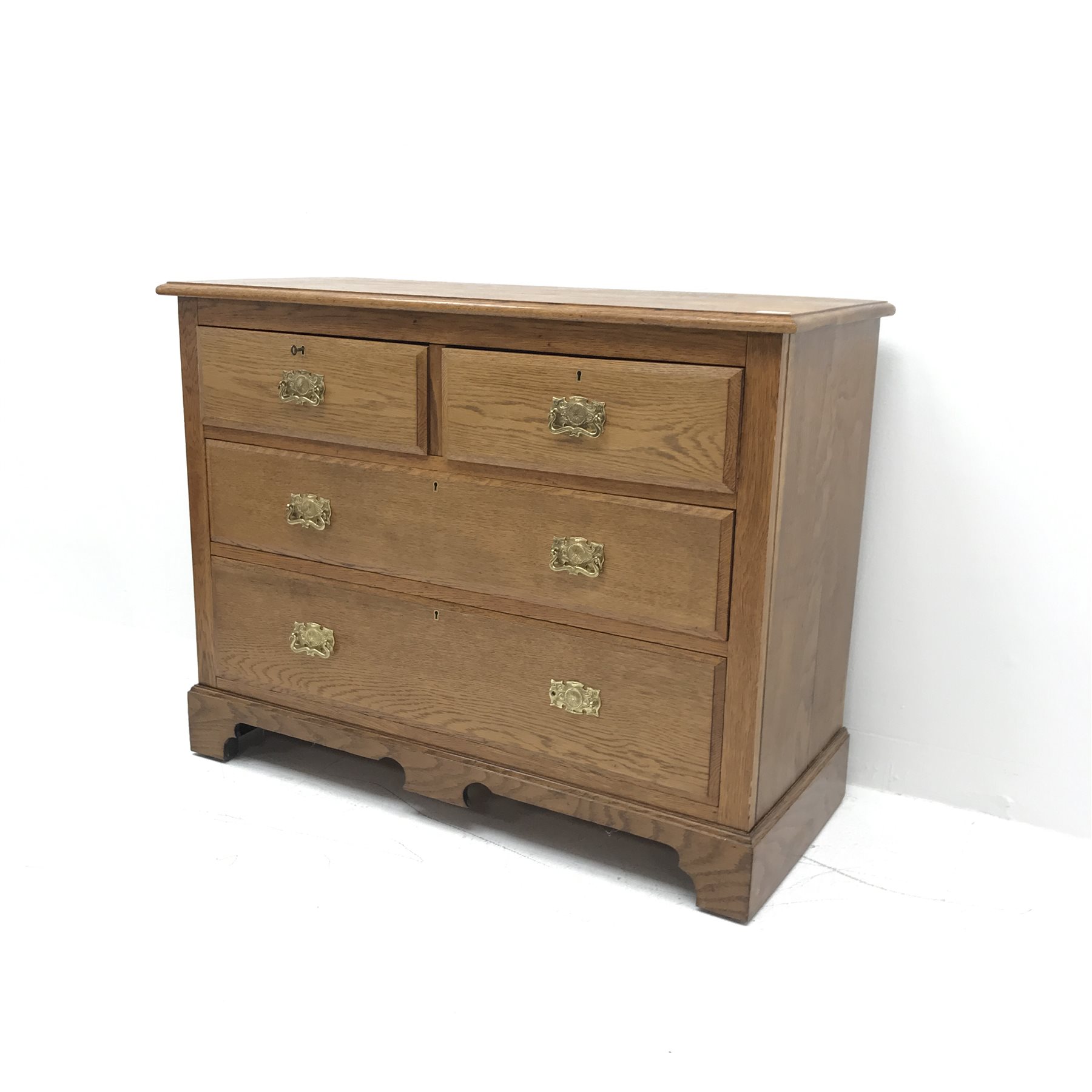 Edwardian oak chest, moulded top, two short and two long drawers, shaped plinth base, W107cm, H82cm,