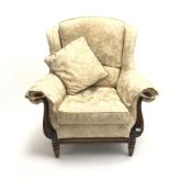 Traditional style armchair upholstered in a patterned pale gold fabric, scrolling arms, turned suppo