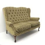 Traditional style two seat sofa, high shaped back upholstered in deep buttoned patterned fabric, cab
