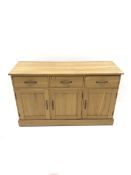 Light oak sideboard, three drawers above three cupboards on plinth base, W137cm