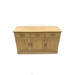 Light oak sideboard, three drawers above three cupboards on plinth base, W137cm