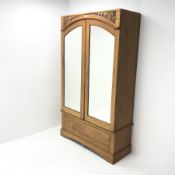 Early 20th century walnut double wardrobe, two mirrored doors enclosing hanging rail above single dr