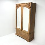 Early 20th century walnut double wardrobe, two mirrored doors enclosing hanging rail above single dr