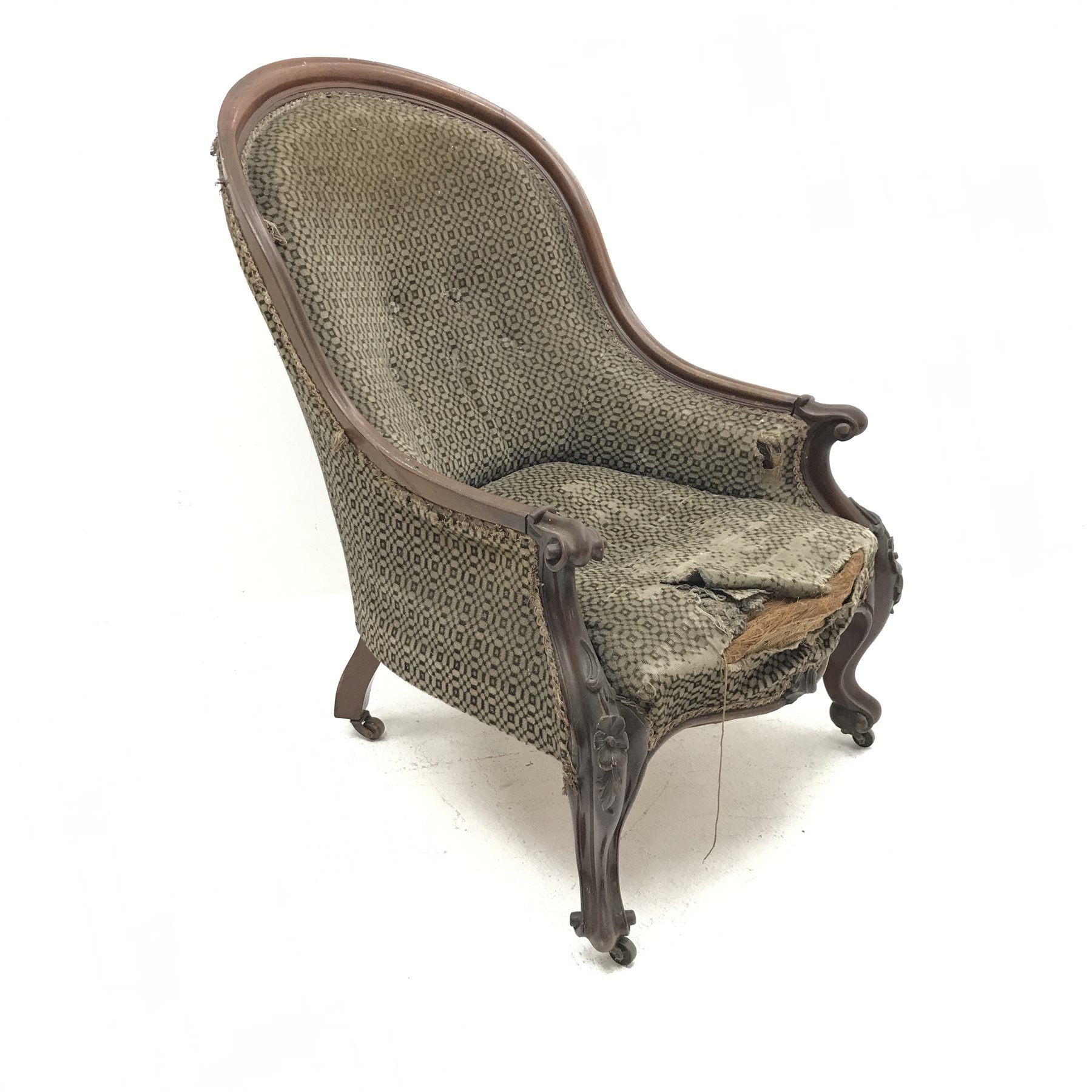 Victorian mahogany framed spoon back armchair, upholstered in a beige ground fabric, floral carved c