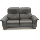 Stressless two seat sofa upholstered in a chocolate leather, shaped supports, W180cm