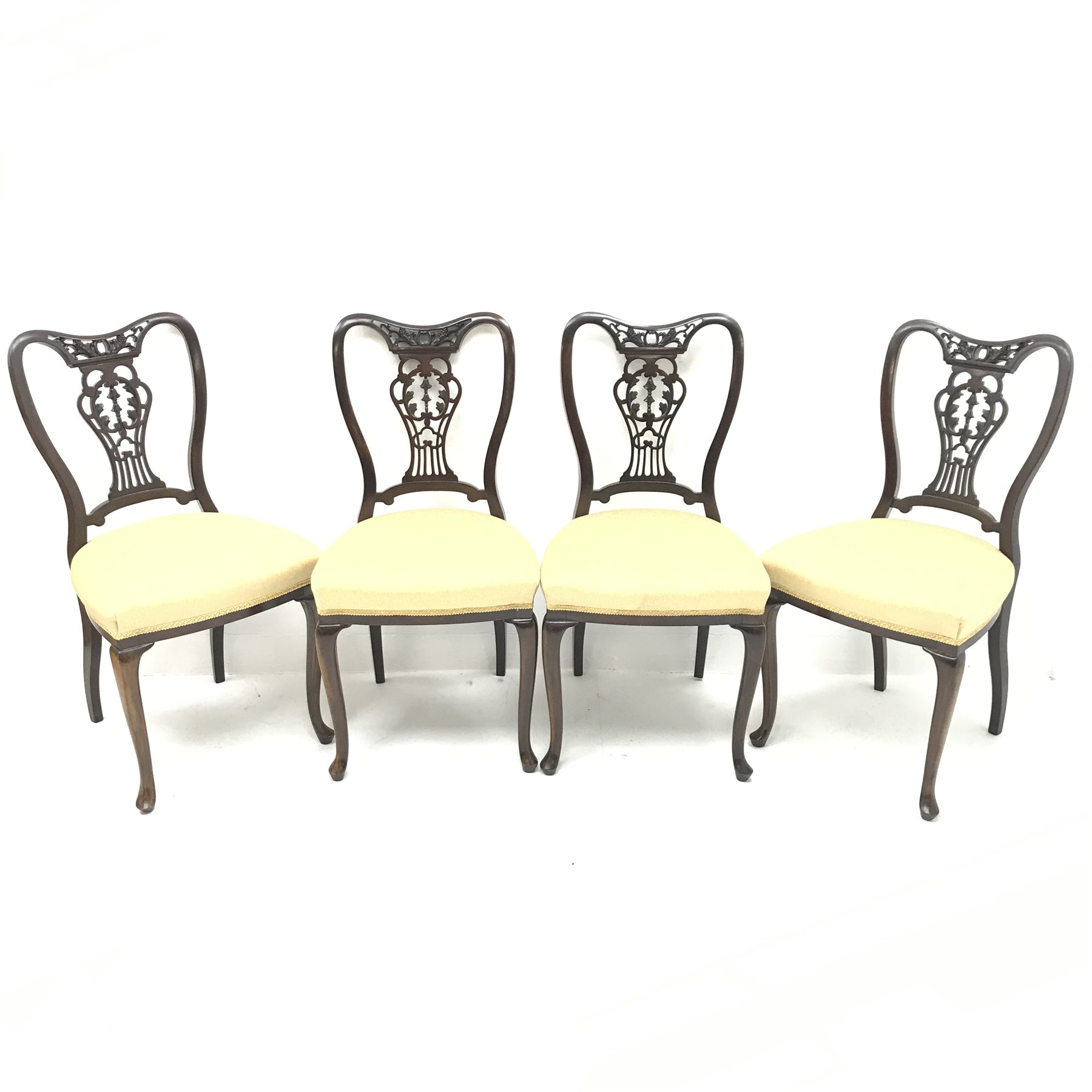 Set four late Victorian mahogany dining chairs, shaped, carved and pierced back, upholstered seat, c