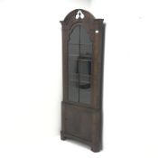 20th century walnut corner cabinet, arched swan neck pediment with central finial, single glazed do