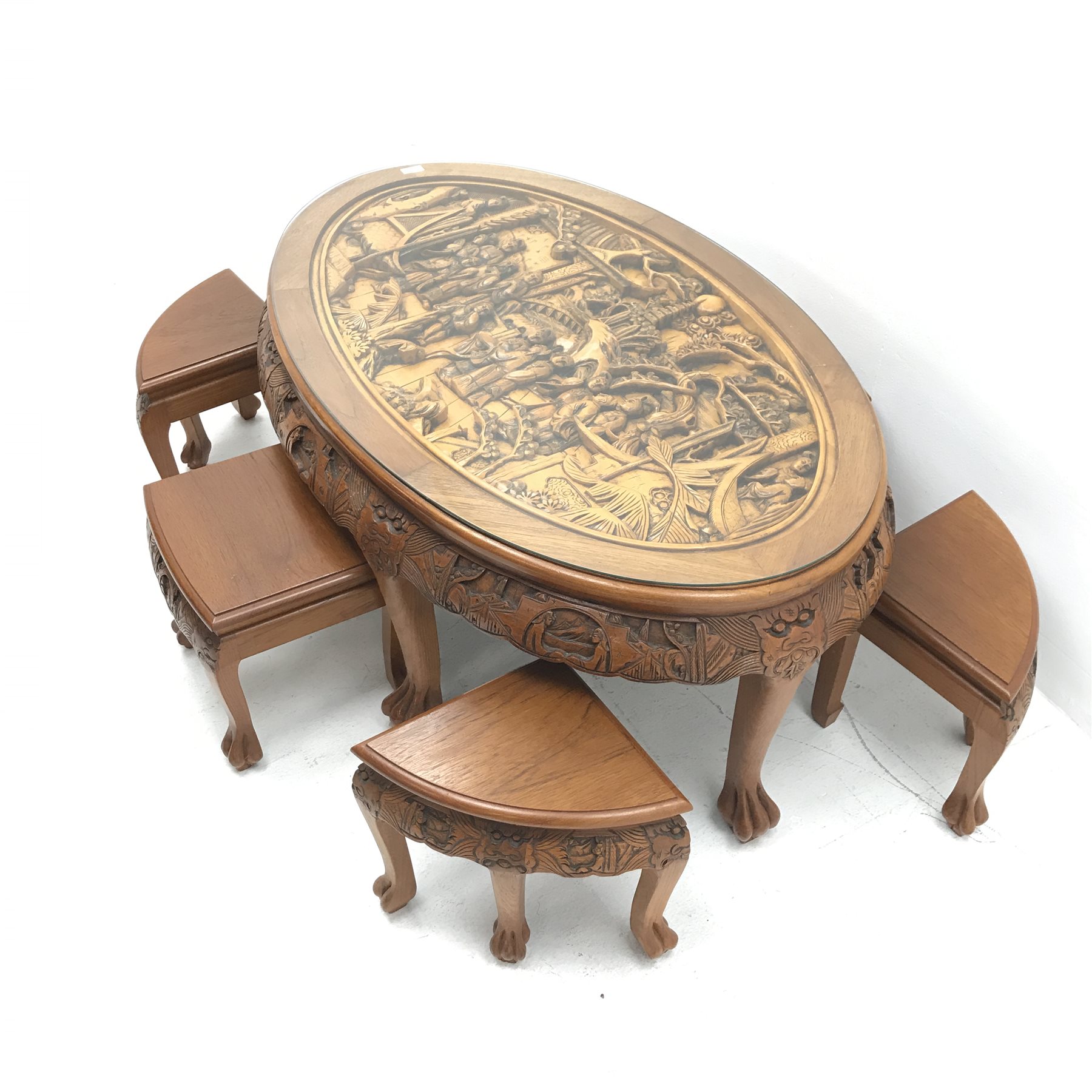 Eastern glass topped oval table decorated in high relief with six integral stools, W124cm, H50cm, D8 - Image 4 of 5