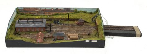 '00' gauge - table top model railway layout with multiple tracks around a central engine shed with o