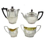 Victorian matched four piece silver tea service half gadrooned body, teapot by Elkington & Co, milk