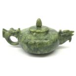 A carved jade teapot, the spout modelled as the head of a bird, the handle modelled as a stylised dr