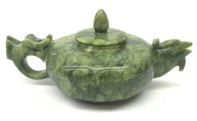 A carved jade teapot, the spout modelled as the head of a bird, the handle modelled as a stylised dr