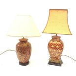 A table lamp of ovoid form, the red ground with gilt foliate decoration, with shade, lamp H45cm, tog