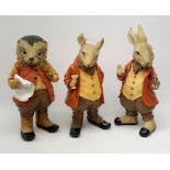 Three composite garden ornaments modelled as woodland animals in human dress, tallest H46cm.