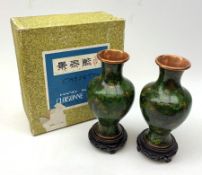 A pair of 20th century cloisonn� vases, of baluster form, the dark green ground decorated with flowe