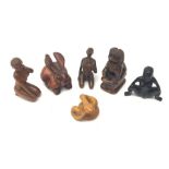 A group of six Japanese carved wooden netsukes modelled in various forms, comprising rabbit, temple